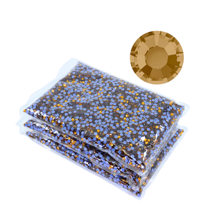 Wholesale packaging of lt colorado topaz rhinestones with a close-up of a single rhinestone on a white background.